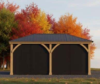 Wooden gazebo with dark aluminium roof and dark mesh curtains in a backyard surrounded by vibrant orange and red autumn trees.