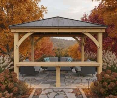 Wooden gazebo with outdoor seating surrounded by colourful autumn trees.