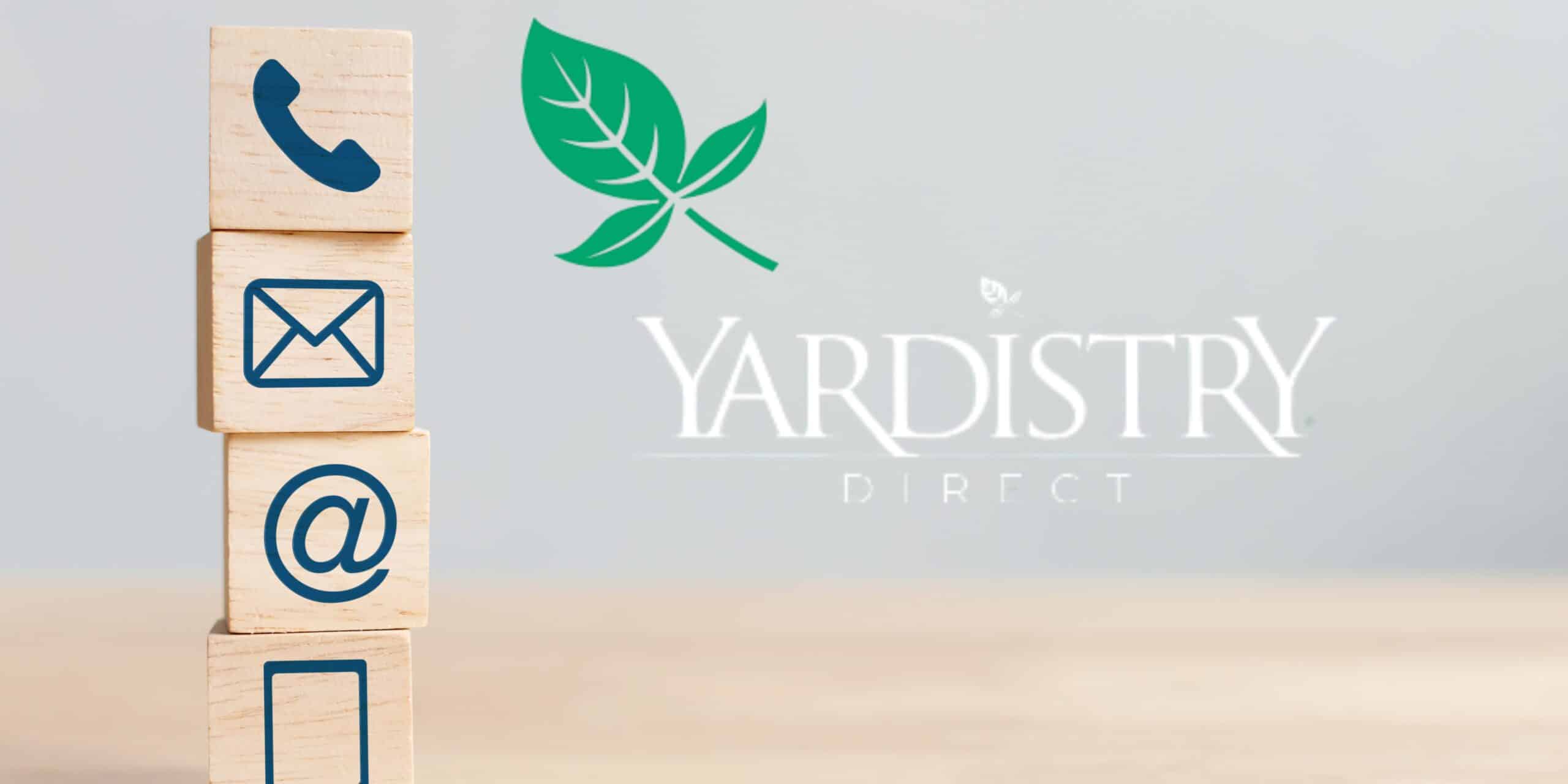Stack of four wooden blocks with blue icons for phone, email, @ symbol, and chat, placed beside a green leaf graphic and “YARDISTRY DIRECT” text on a soft grey background.